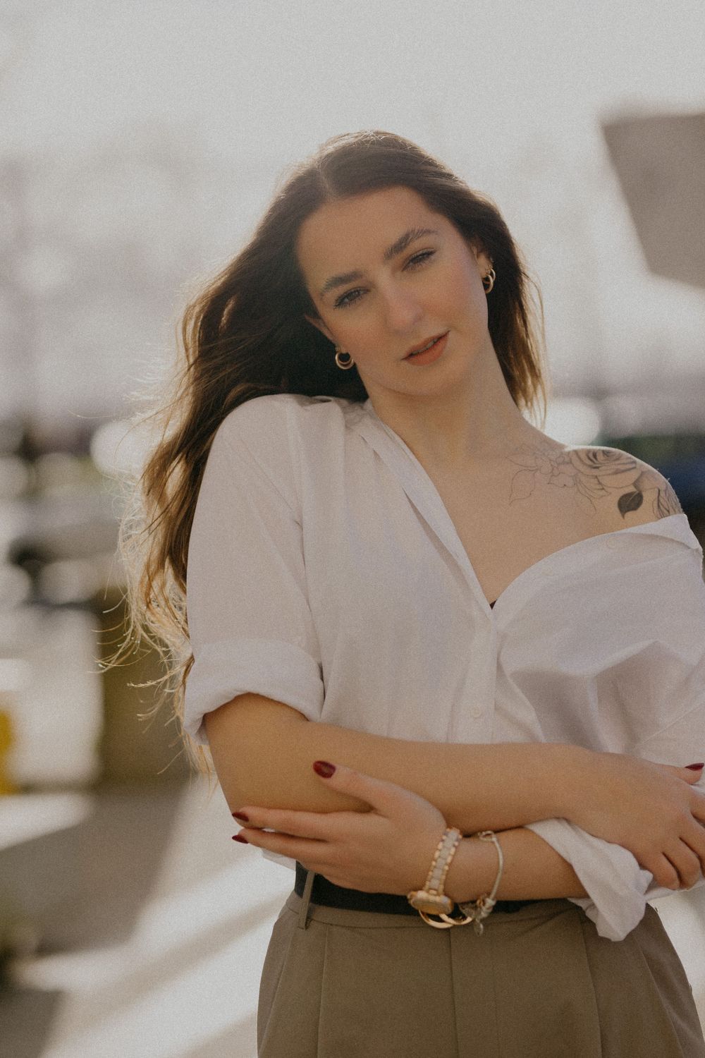 Casual fashion portrait featuring a white button-down shirt styled with olive high-waisted pants.