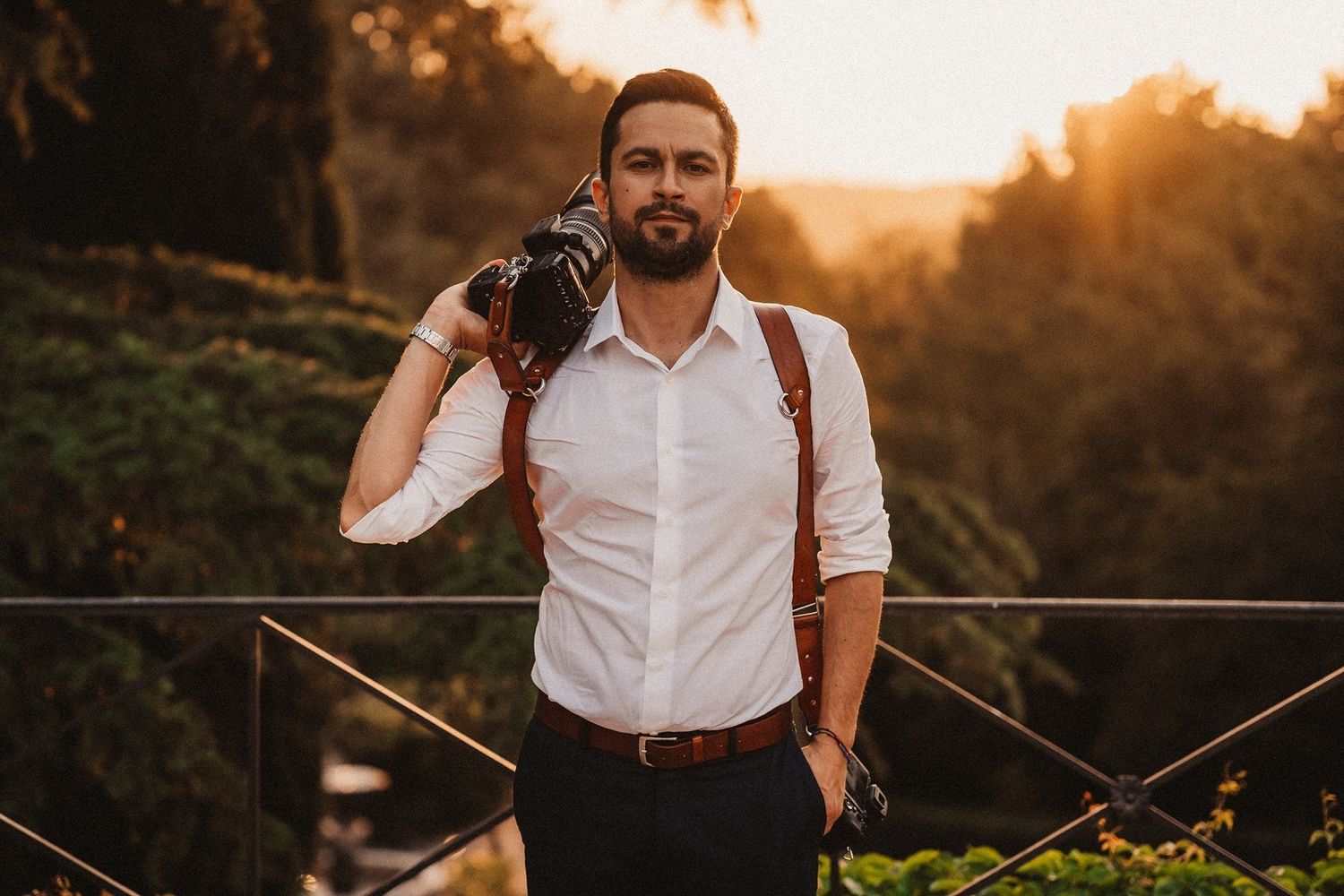 Sunset wedding portraits in rustic vineyard with golden hour lighting.