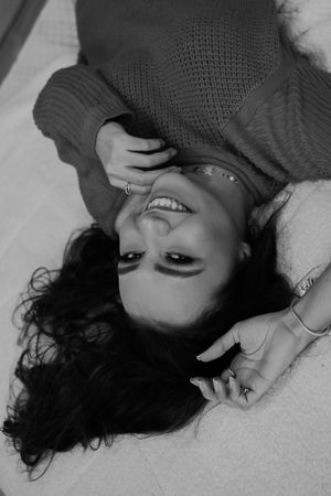 Artistic black and white portraits showing woman lying down with expressive poses.
