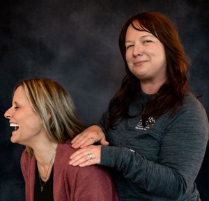 Two people sharing a candid laughing moment during a studio photo session.