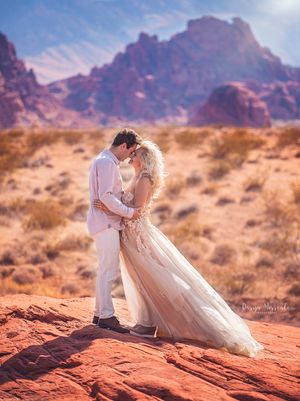 Desert wedding portrait with stunning mountain backdrop in Valley of Fire.