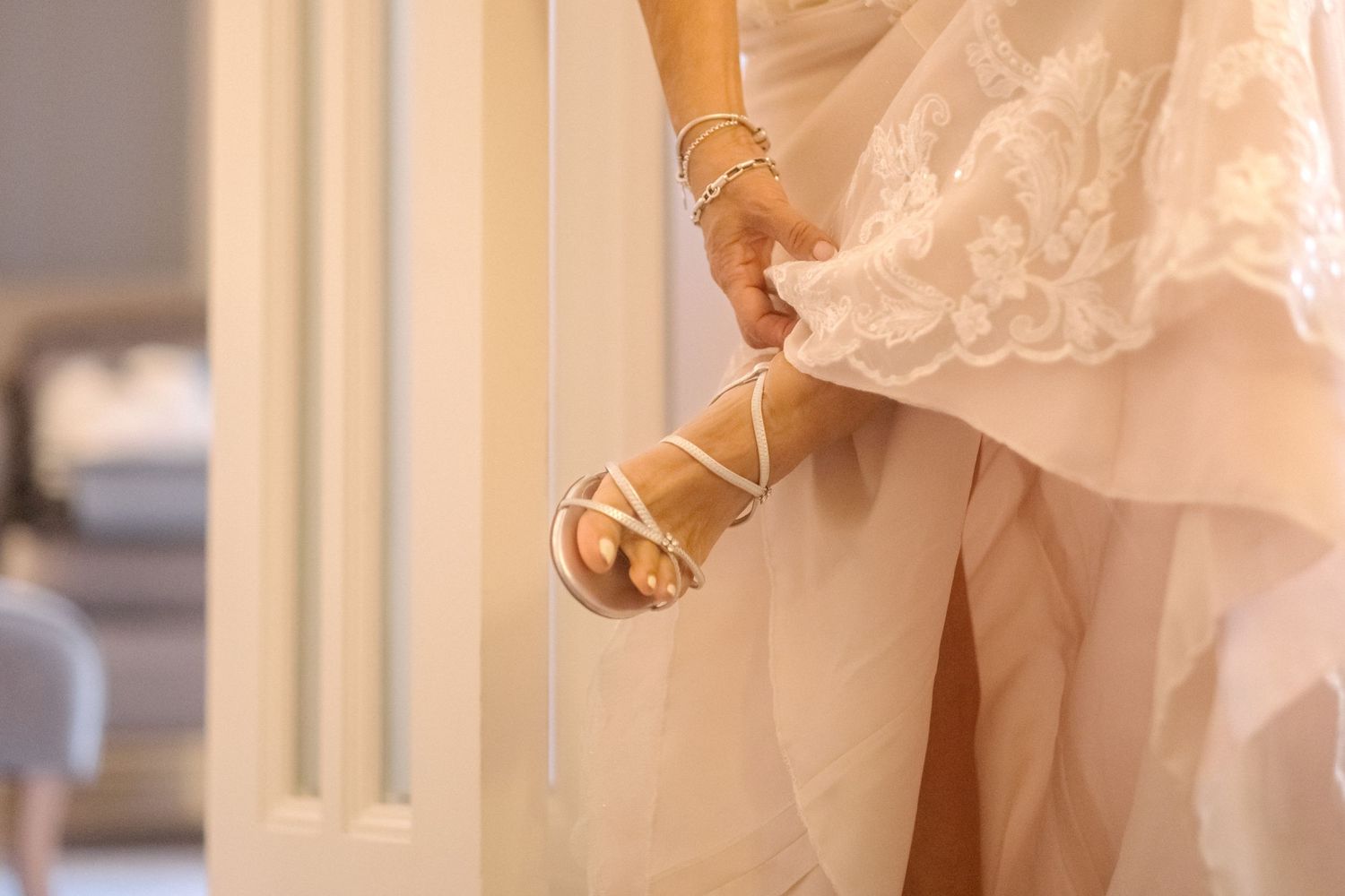A bride adjusts her shoe before her London wedding.