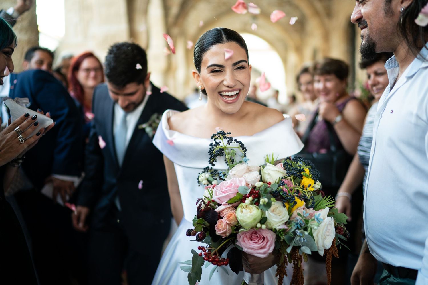 Bride leads Groom through confetti after their wedding at st Lazarus Larnaca in Cyprus