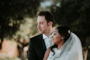 Intimate wedding portrait captured in warm natural sunlight.