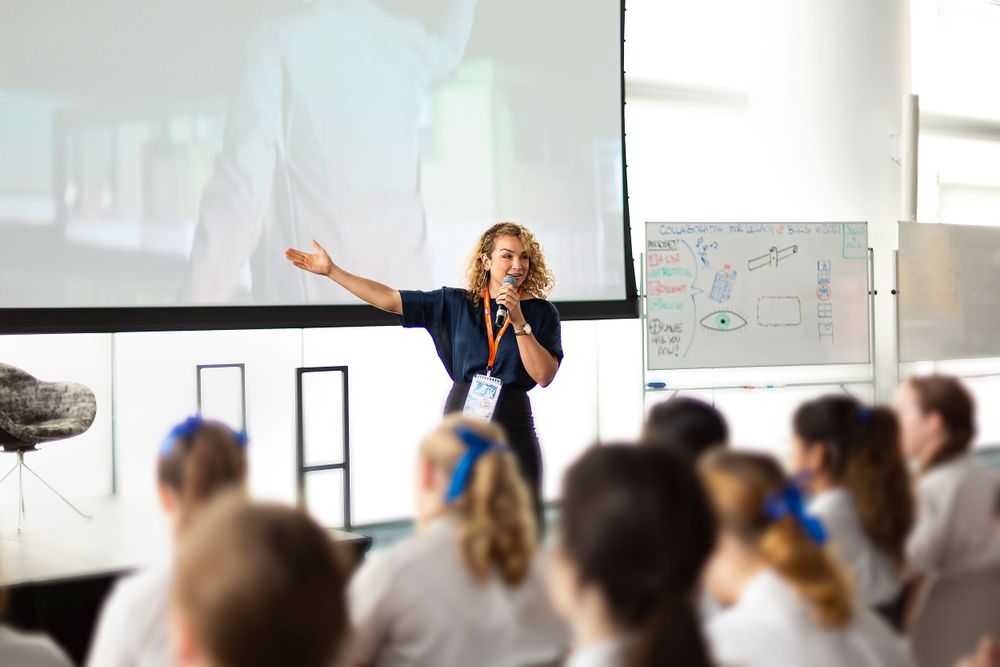 Corporate conference room filled with attendees during business presentation.