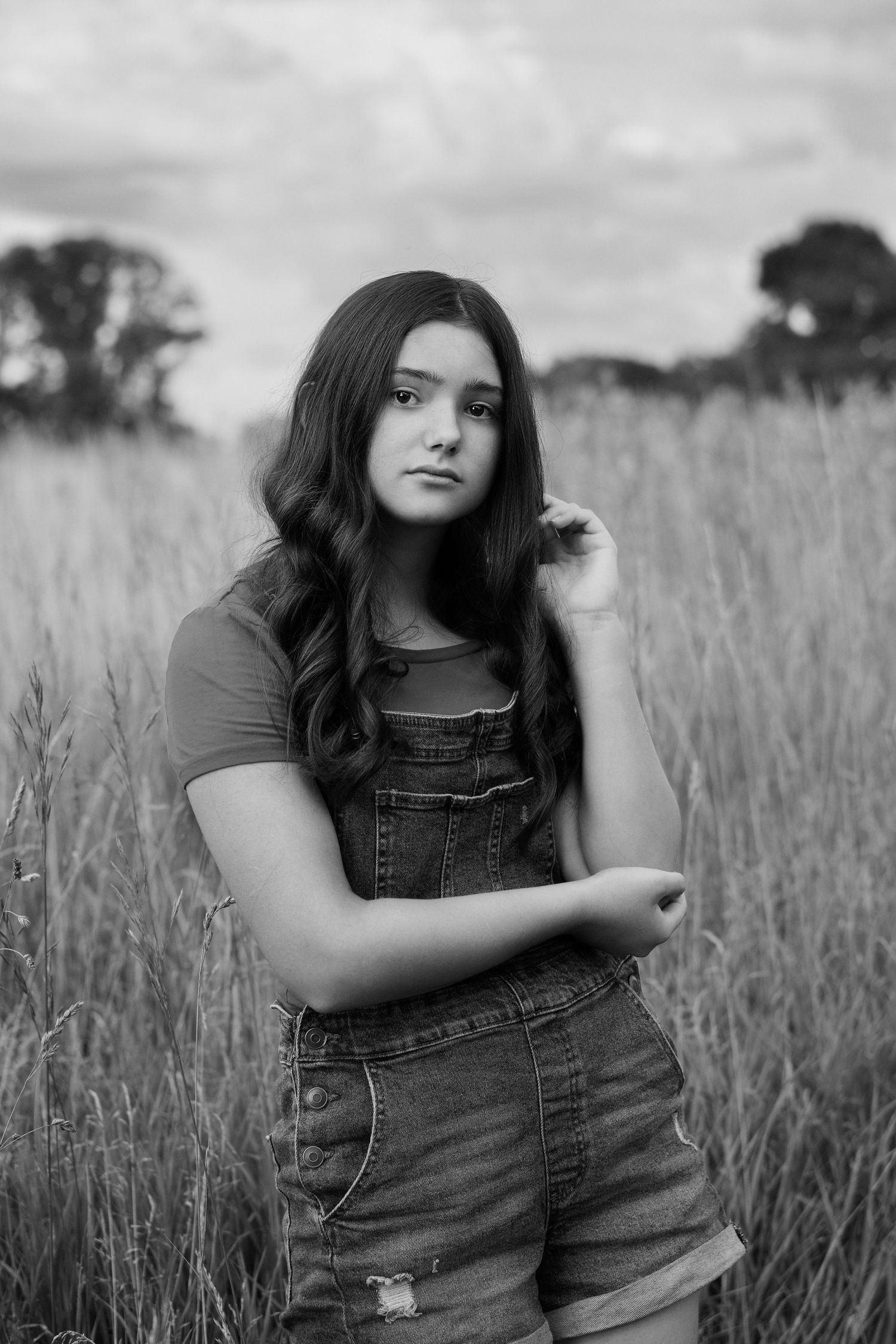 girl poses in grassy field