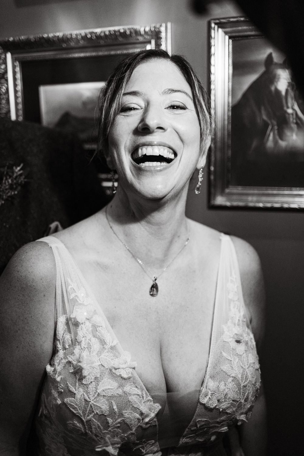 Black and white candid portrait showing joyful laughter in vintage-inspired setting.