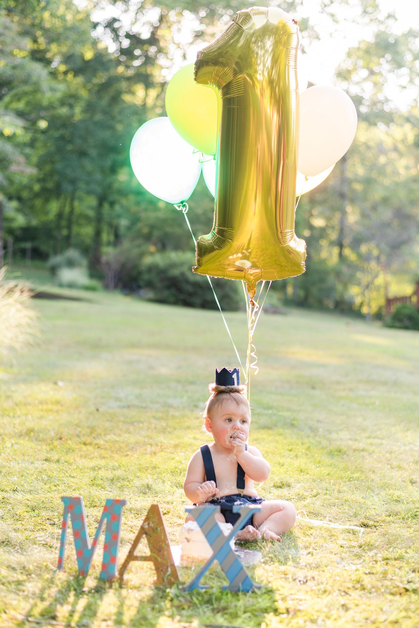 Baby with first birthday balloons and cake in Pittsburgh, Pennsylvania