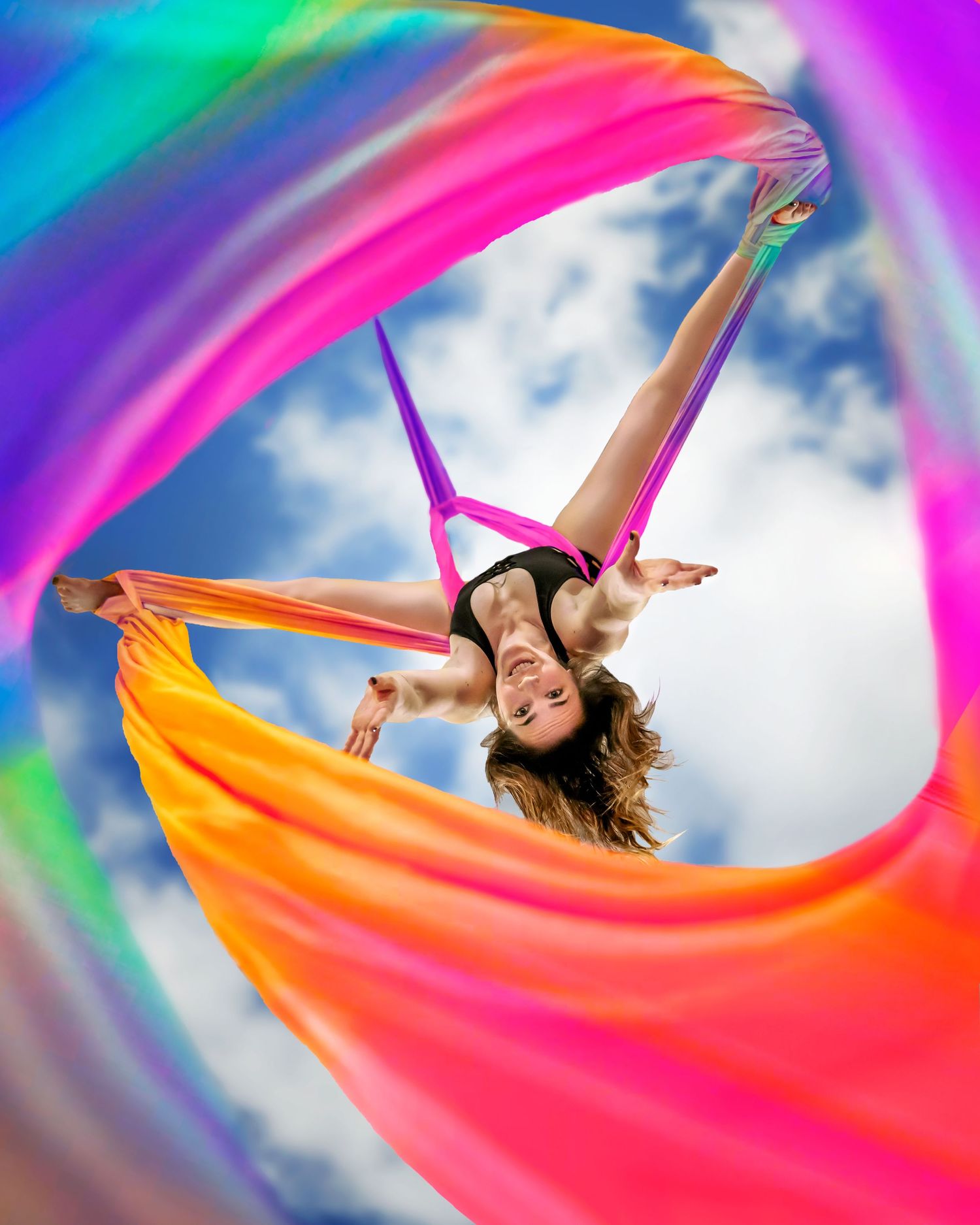 Tri-Cities aerial photographer woman hanging upside down under rainbow silks by washington aerial photographer