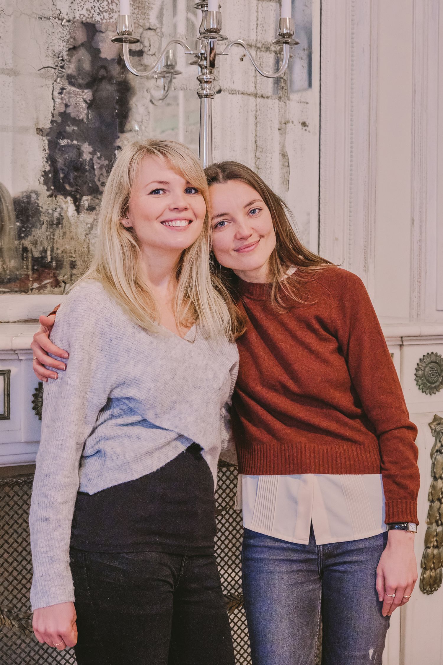 Two friends in casual sweaters pose together in a series of candid shots against a white background.
