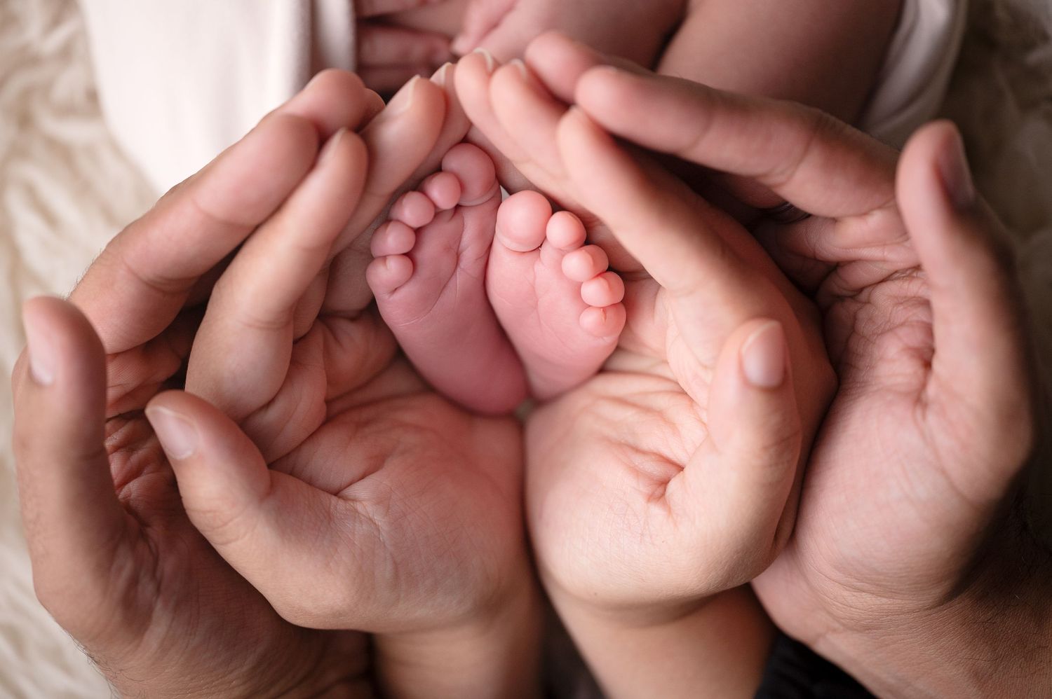 Multiple artistic close-up shots of newborn baby feet and hands.
