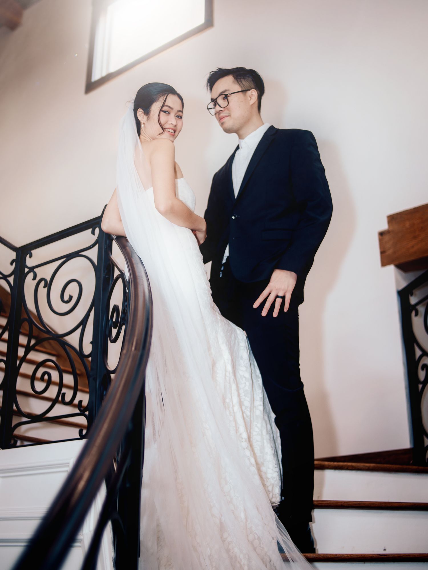 Wedding at Primrose Hill with ivory dress, sage colored flowers and arches, and groom in royal blue suit.