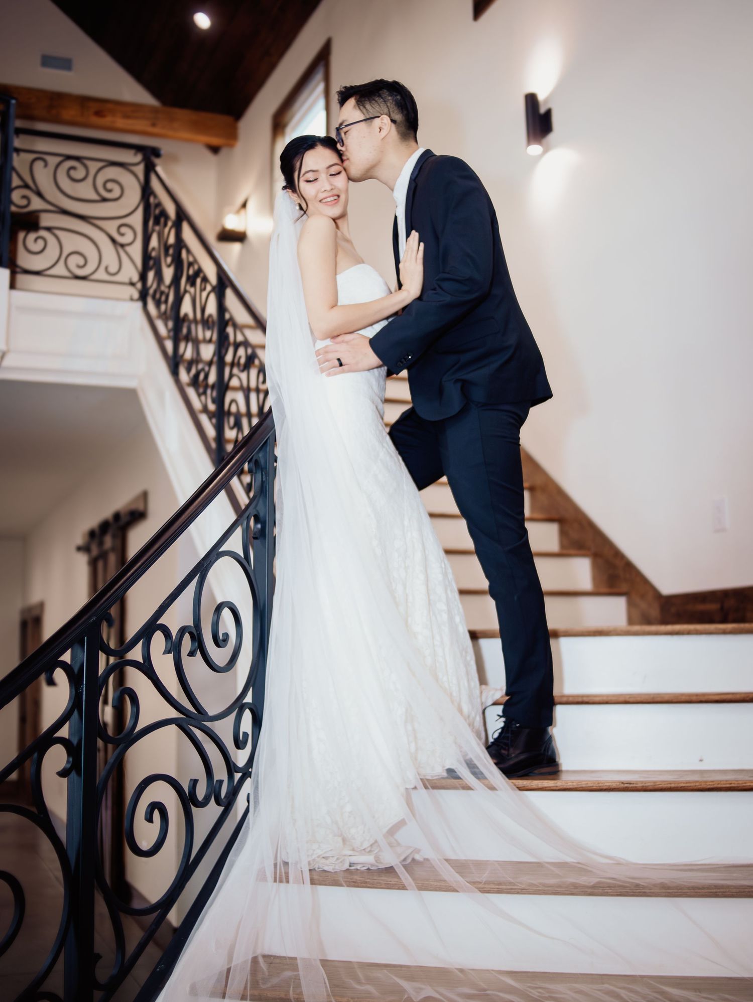 Wedding at Primrose Hill with ivory dress, sage colored flowers and arches, and groom in royal blue suit.