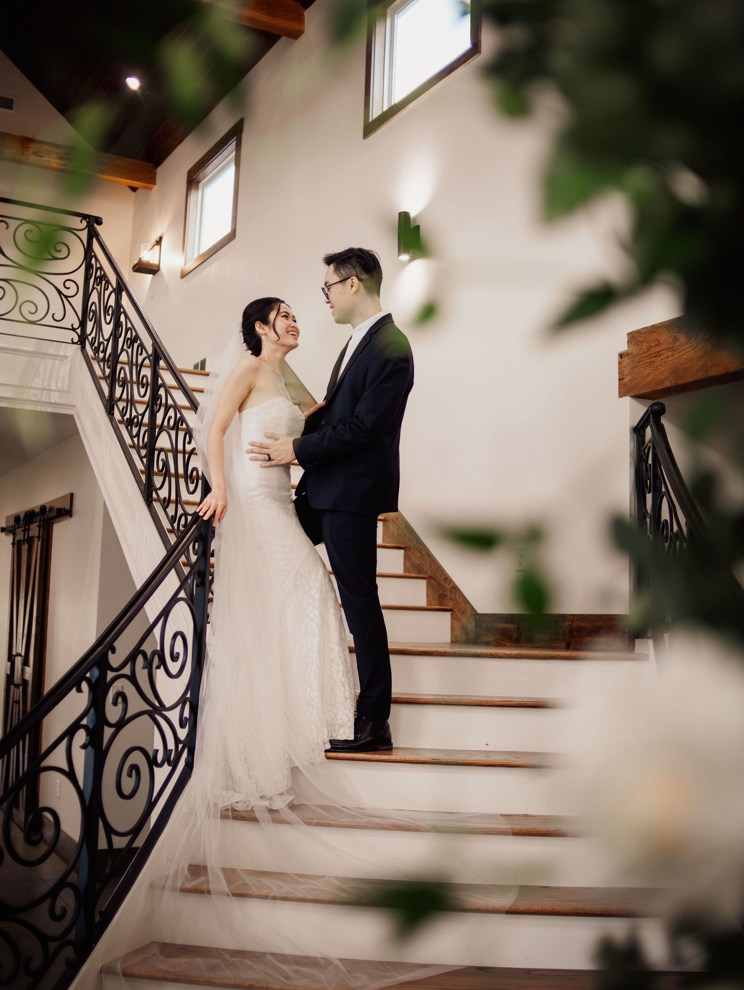 Wedding at Primrose Hill with ivory dress, sage colored flowers and arches, and groom in royal blue suit.