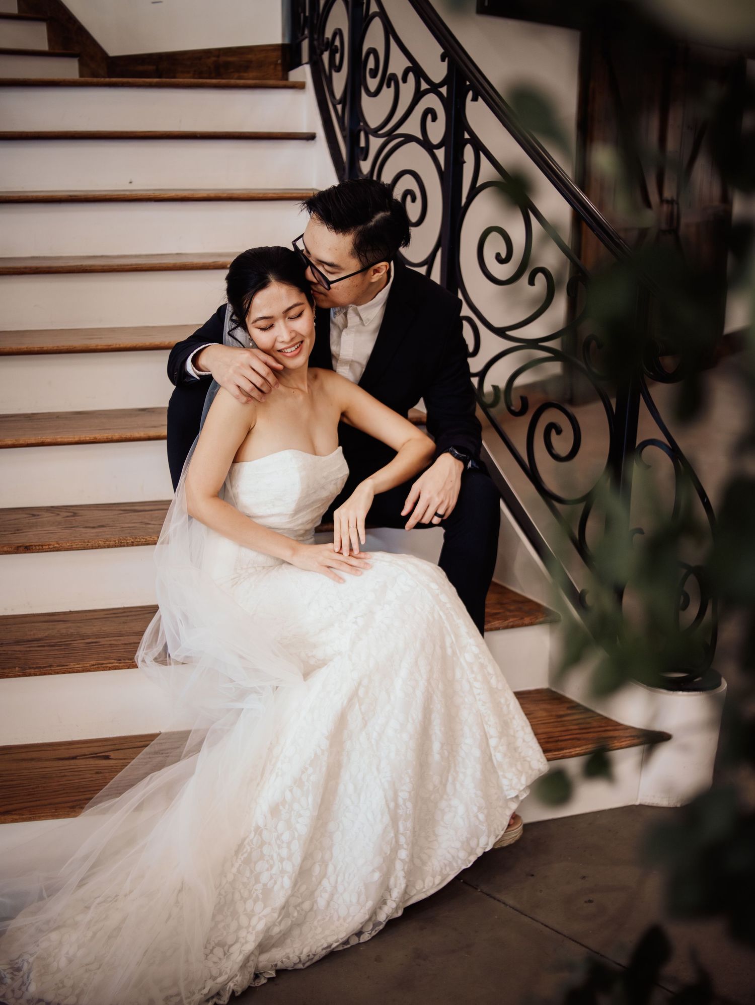 Wedding at Primrose Hill with ivory dress, sage colored flowers and arches, and groom in royal blue suit.