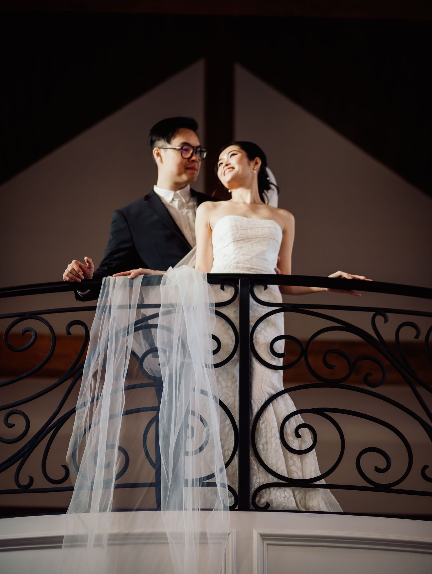 Wedding at Primrose Hill with ivory dress, sage colored flowers and arches, and groom in royal blue suit.