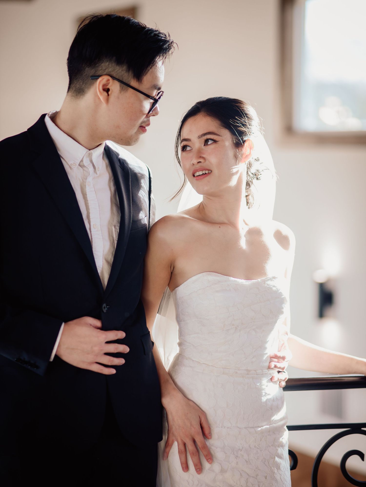 Wedding at Primrose Hill with ivory dress, sage colored flowers and arches, and groom in royal blue suit.