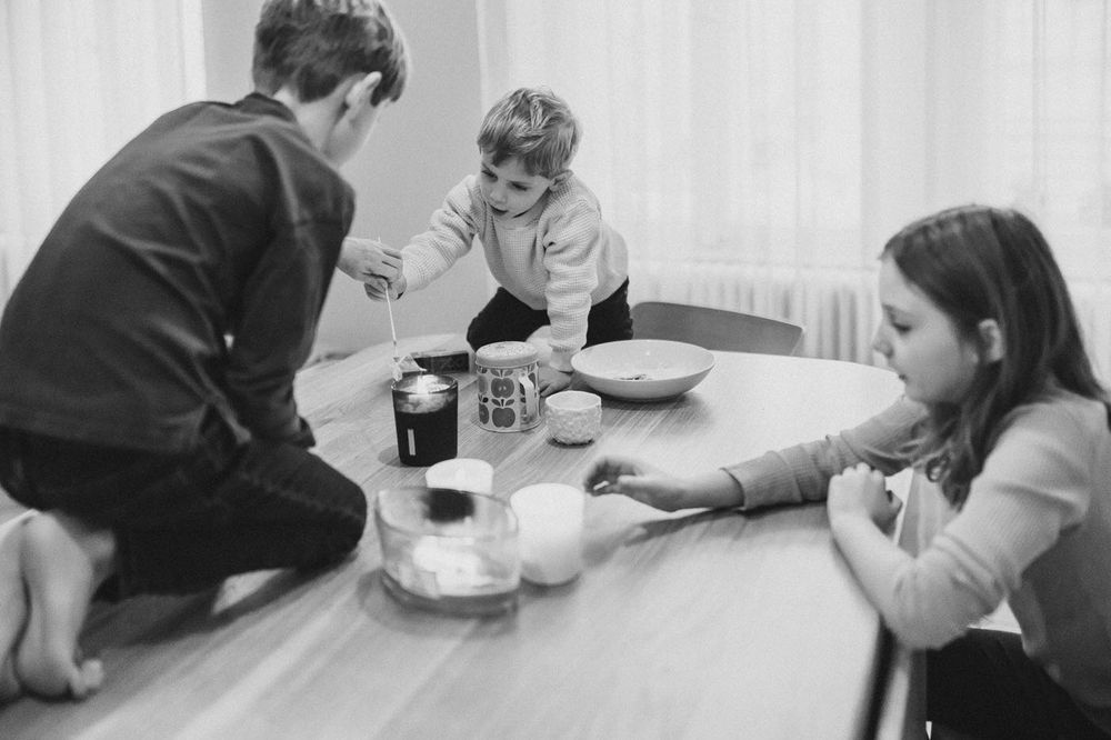 Group enjoying a casual meal together at home in black and white photography.