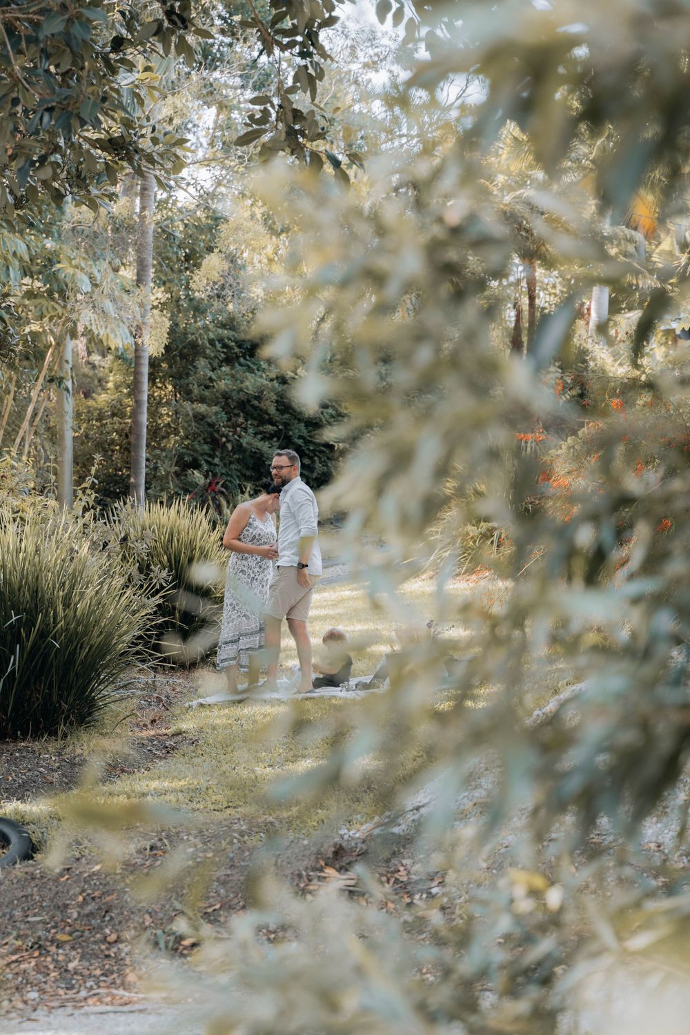 A romantic garden moment captured through leaves and branches.