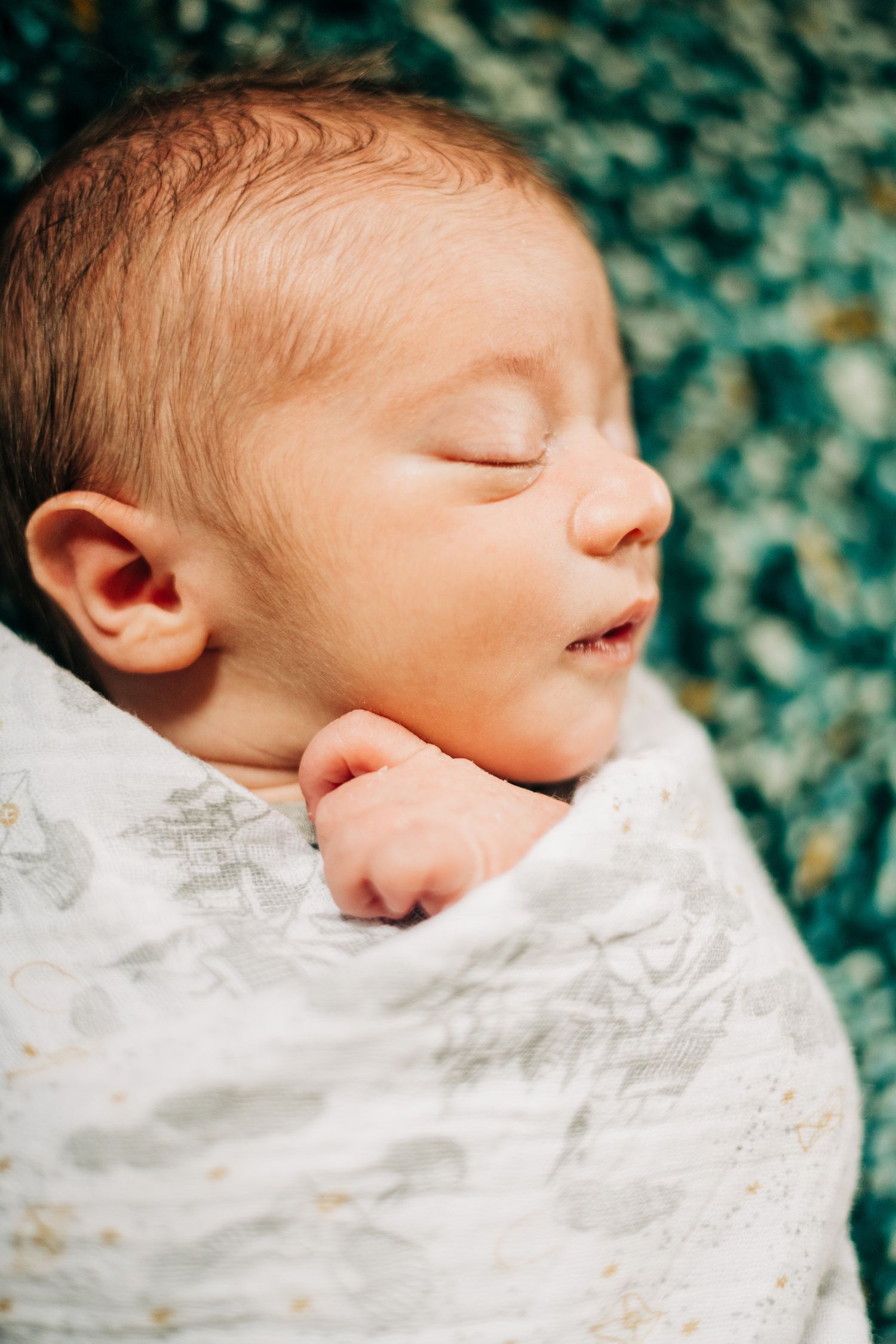 close up of sleeping baby's face and hand