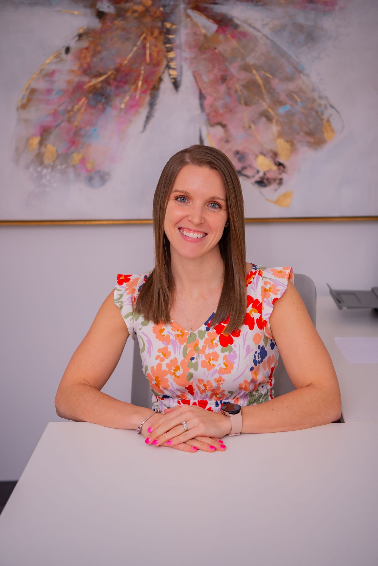 female doctor sitting at work desk ashley loughner