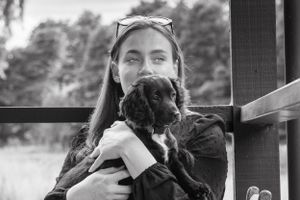 Black and white sequence showing dogs and their owners on a porch.