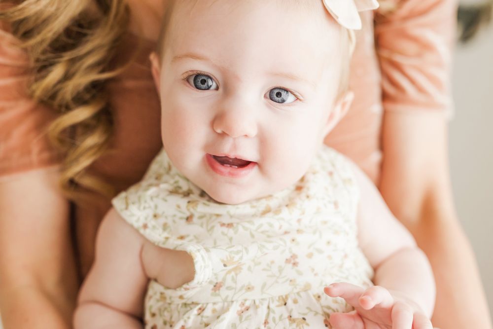 baby girl looking at camera close up bright blue eyes