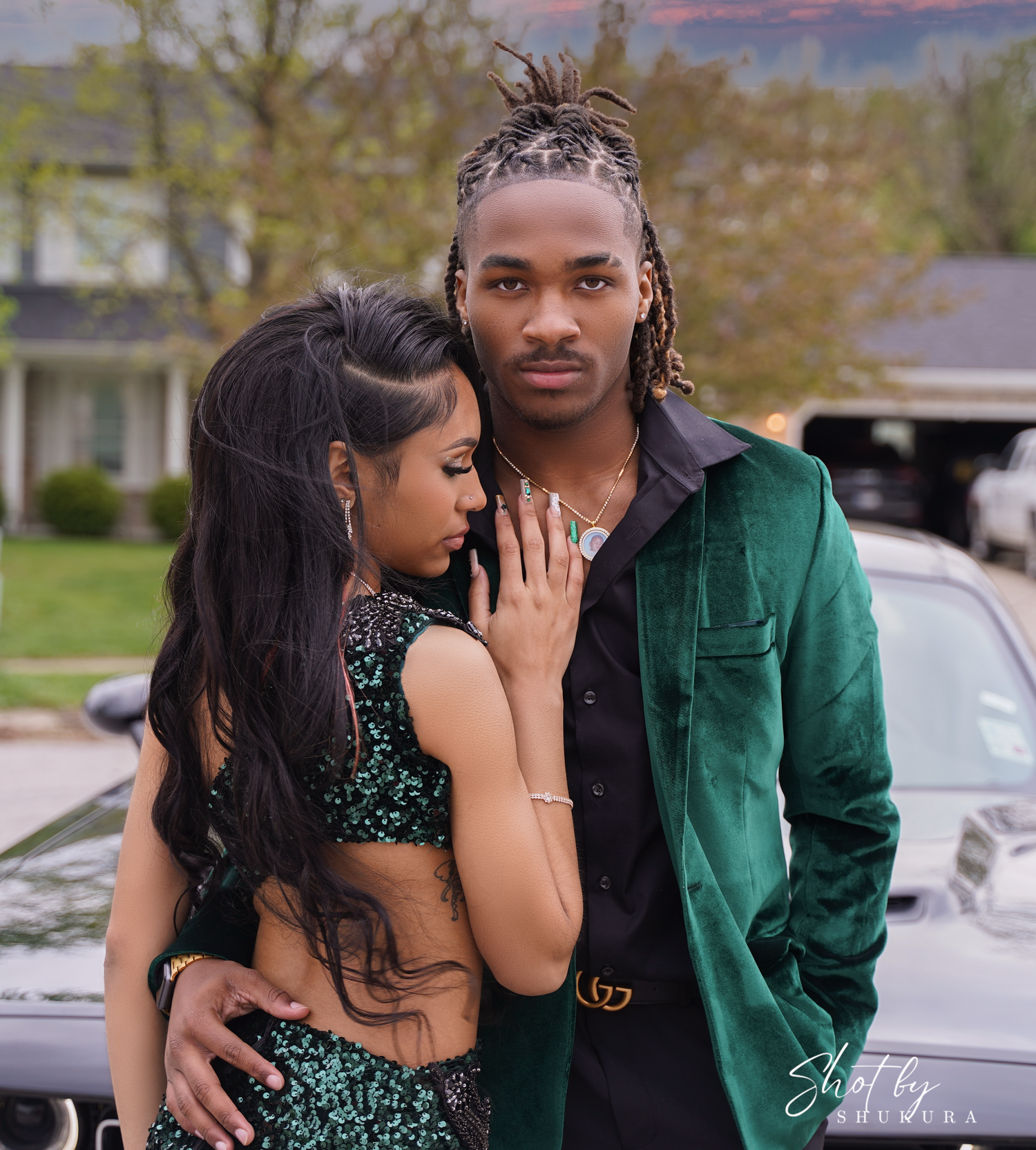 Couple in formal wear sharing an intimate moment outdoors.