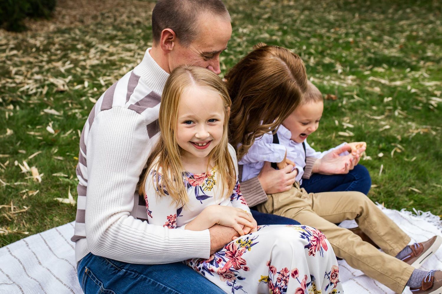 Two kids sitting on their parents lap in Kirkland Washington