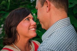 A tender moment shared between a couple during an outdoor photoshoot.