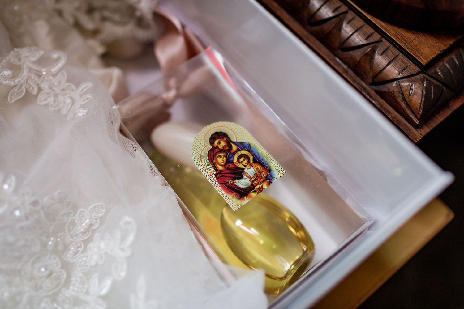 Yellow christening gown or baptismal robe carefully folded in a white box.