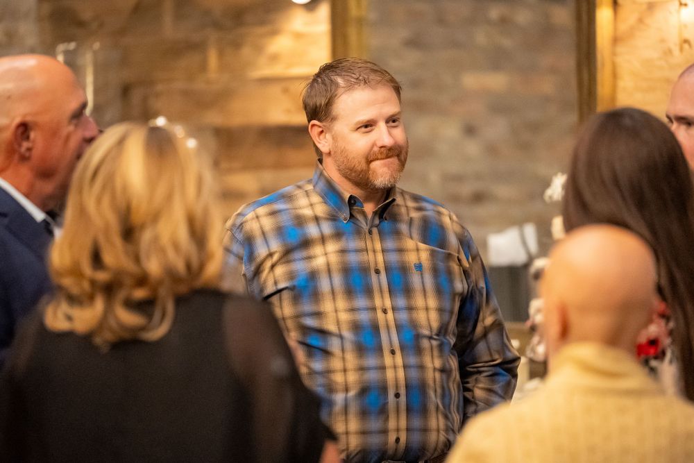 Social gathering in rustic venue with exposed brick walls and warm ambient lighting.