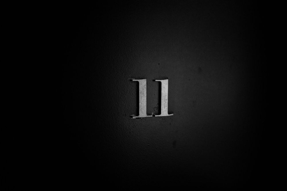 Number 11 displayed in metallic text against a dark background.