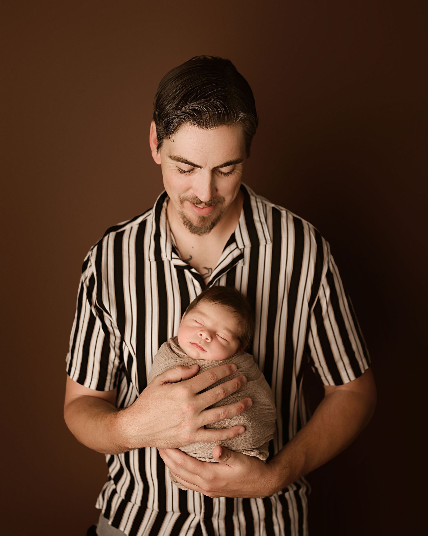Professional newborn photoshoot in Moreno Valley CA, dad with baby boy