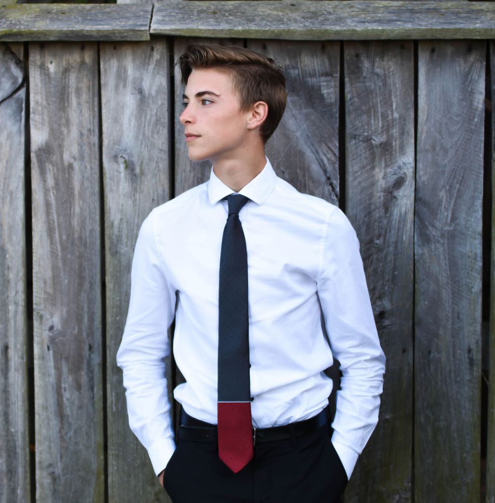 Professional portrait of someone in business attire against a weathered wooden fence. Senior photographer Batavia Cincinnati Ohio