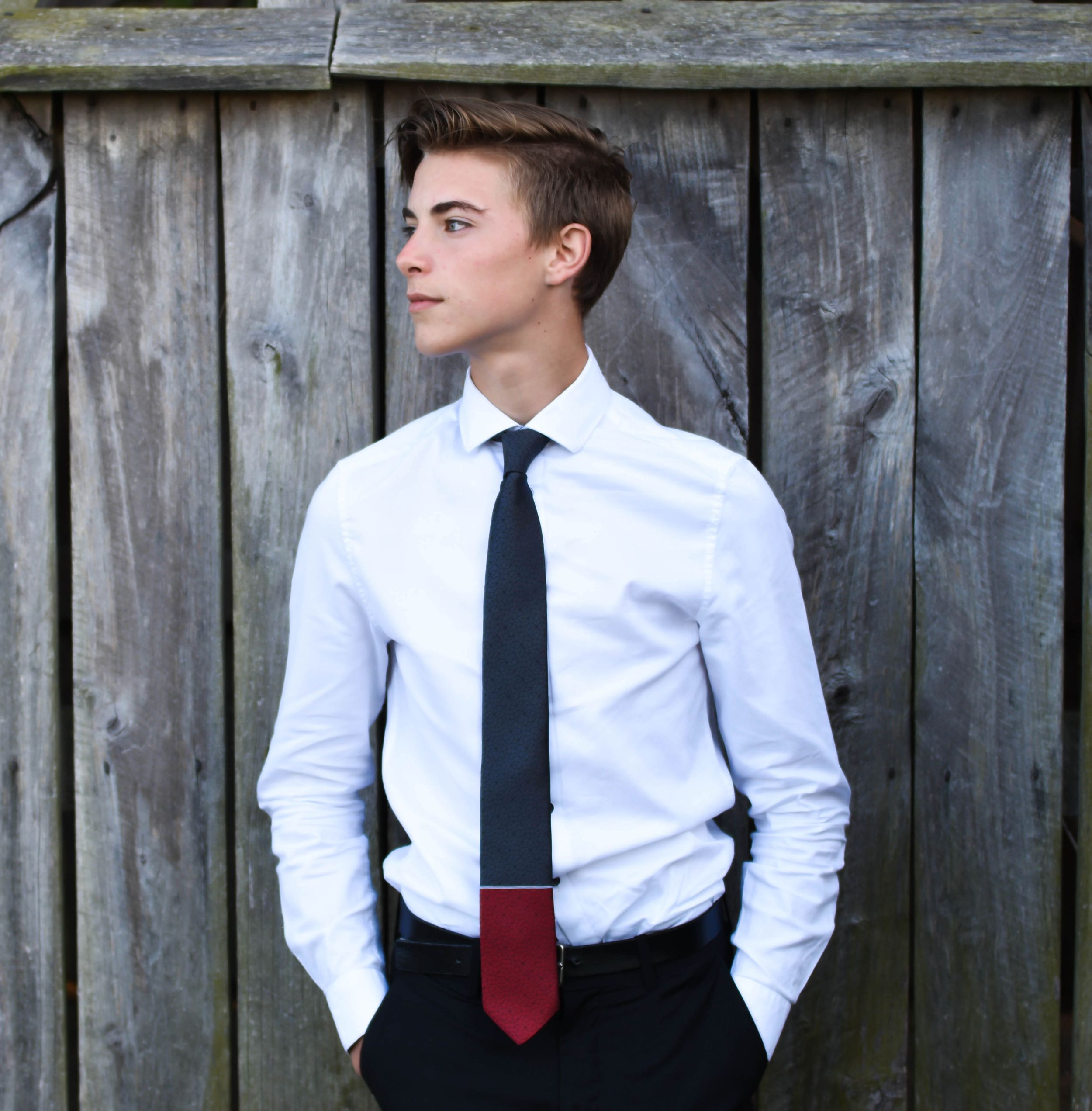 Professional portrait of someone in business attire against a weathered wooden fence. Senior photographer Batavia Cincinnati Ohio