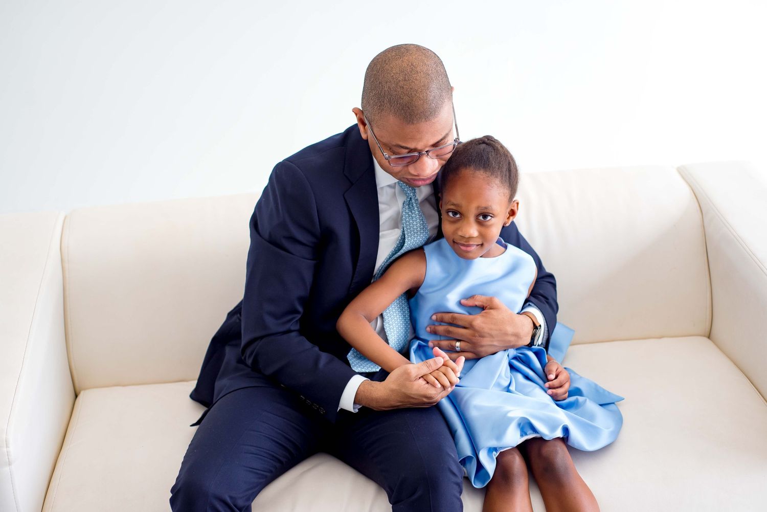 daughter and father taking pictures together in a white studio houston texas