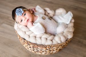 Newborn baby girl awake in basket. Annapolis newborn photographer. Annapolis newborn photography studio
