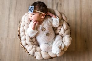 Newborn photo of baby girl in basket. Annapolis newborn photographer. Annapolis newborn photography studio