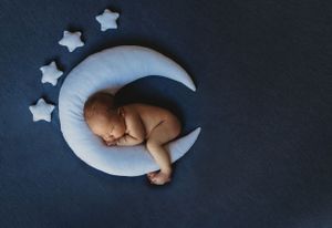 Newborn photo with baby on moon with stars. Annapolis newborn photographer. Baltimore newborn photographer