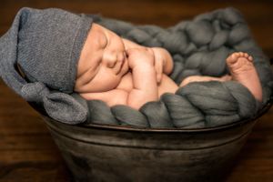 Posed newborn photo of baby in bucket