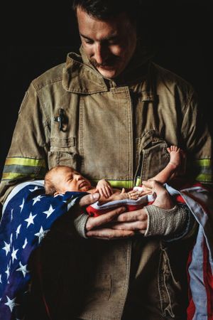 Posed newborn photo with firefighter dad. Annapolis newborn photographer. Maryland newborn photographer. Annapolis photography