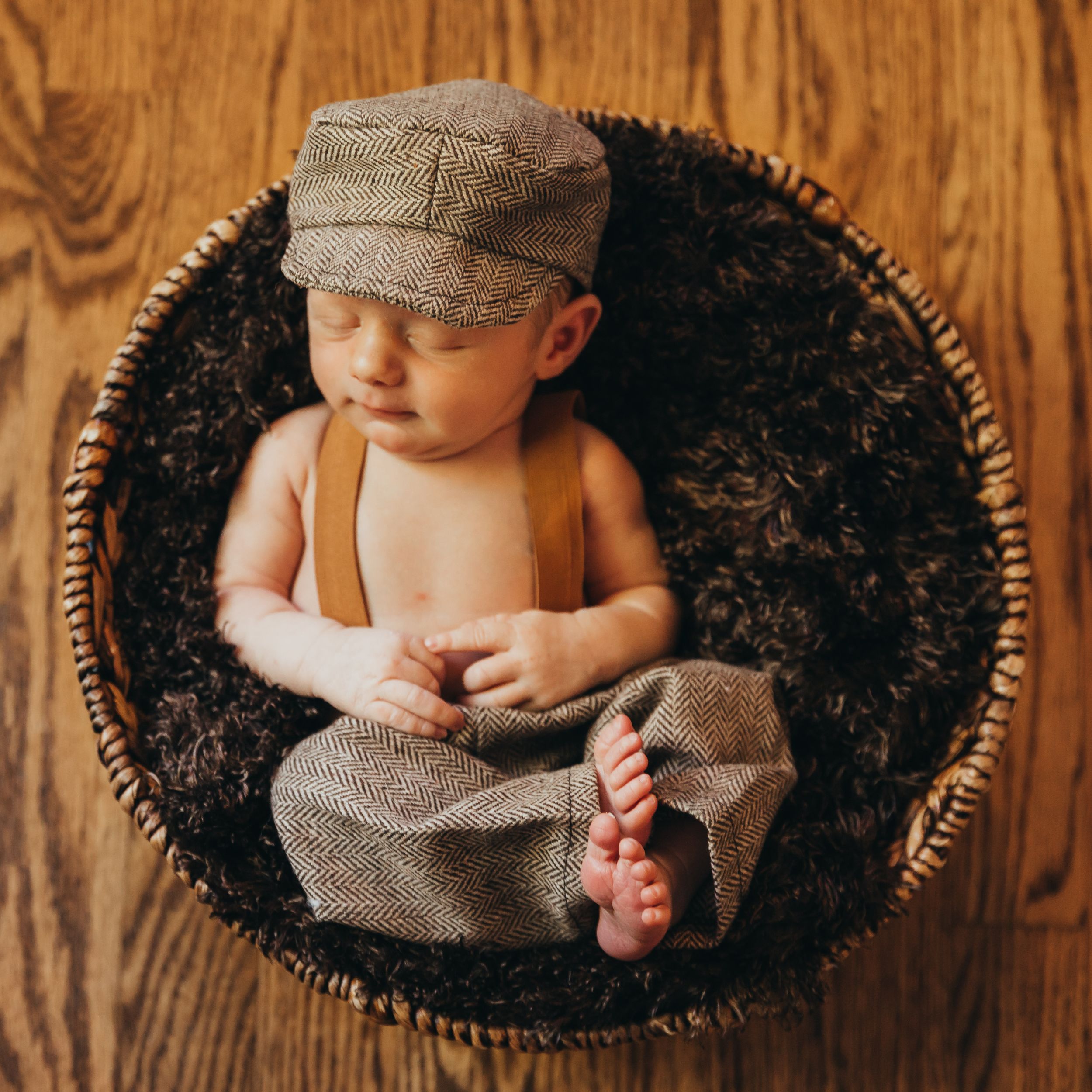 Sleeping baby boy in basket with cute costume. Annapolis newborn photography studio