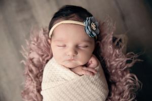Posed newborn girl in prop. Annapolis newborn photographer