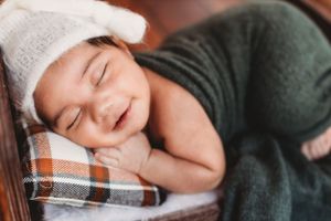 posed smiling newborn baby boy sleeping. Annapolis newborn photographer
