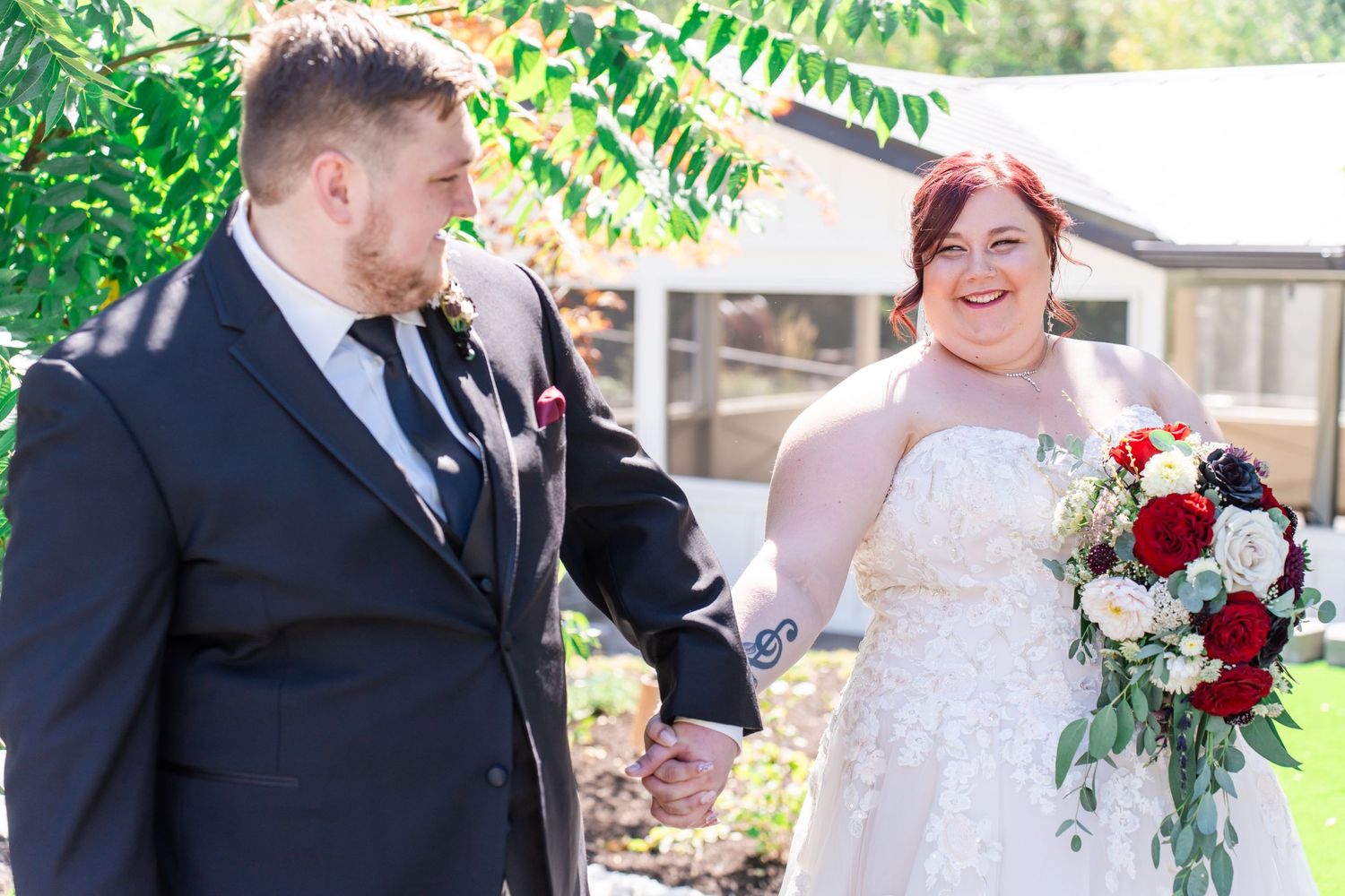 groom leads bride while laughing