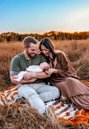 baby with parents in Kansas field