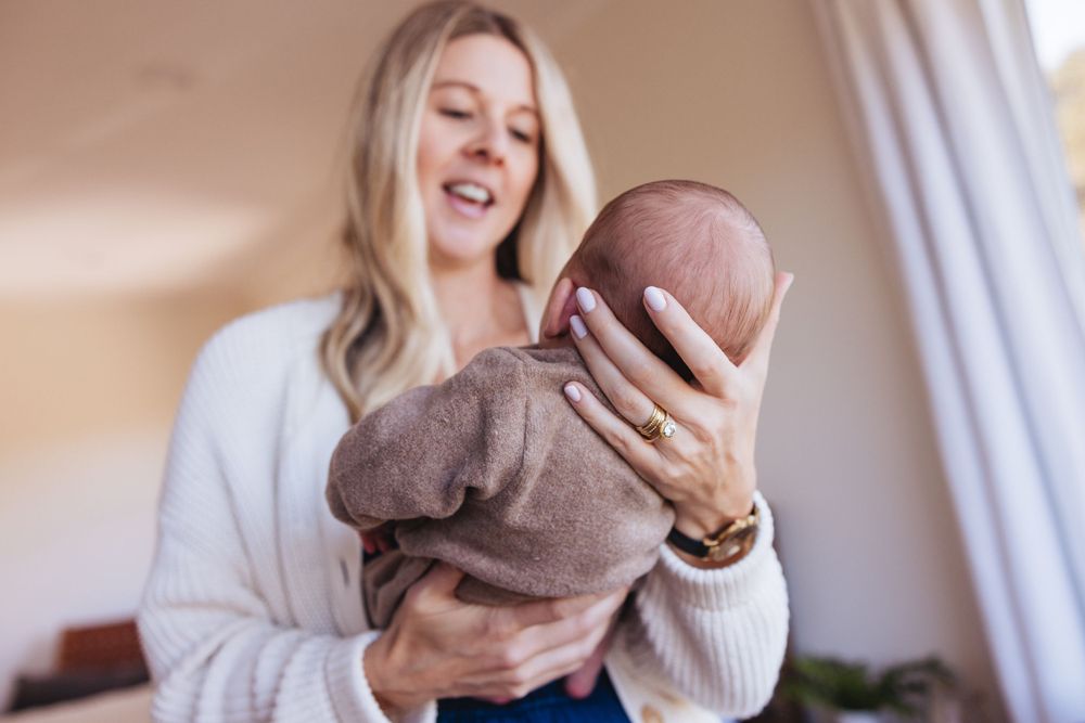 Tender family moment with soft embraces in natural light.