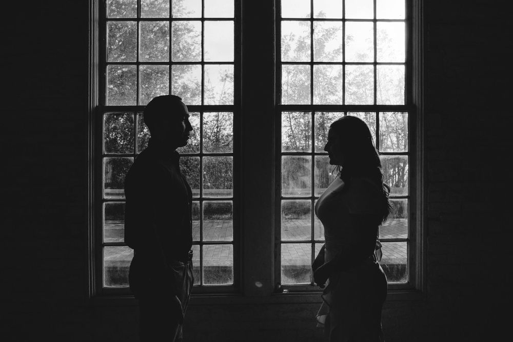 couple standing next to window. backlights. Old Hidalgo Pump House. Hidalgo, Texas. Wedding photographer