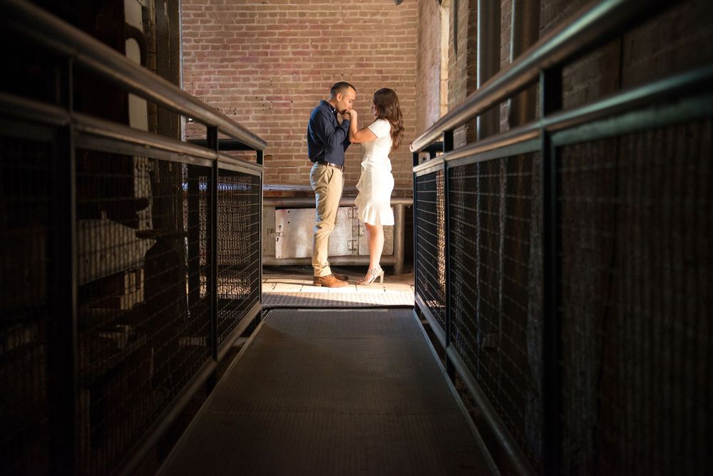 guy kissing girl's hand. Old Hidalgo Pump House. Hidalgo, Texas. Wedding photographer